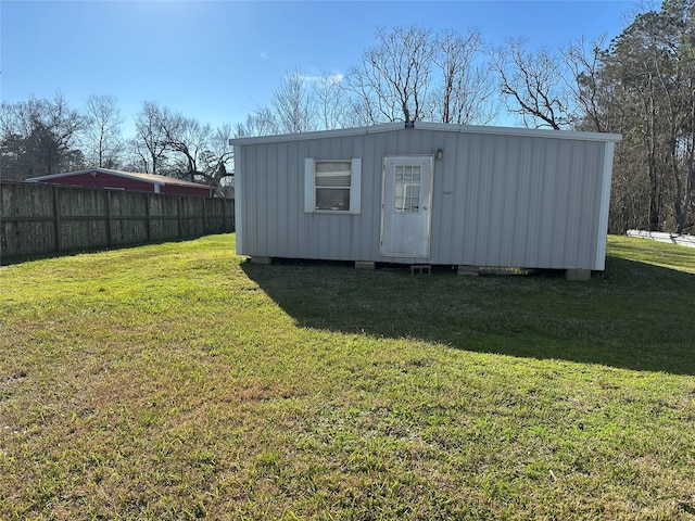 view of outbuilding featuring an outdoor structure and fence