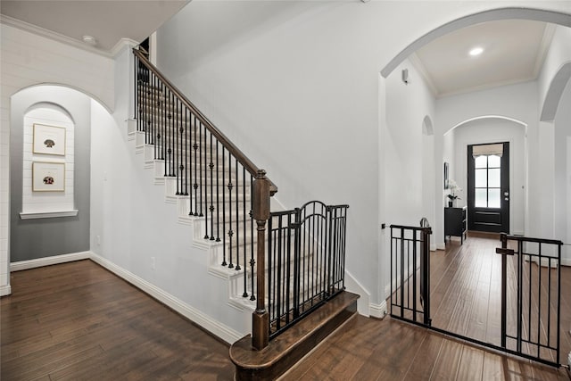 entryway with wood-type flooring and ornamental molding