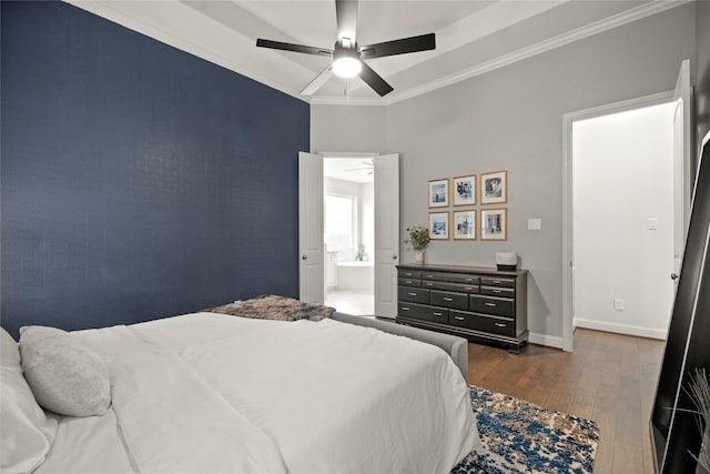 bedroom featuring crown molding, ensuite bath, dark hardwood / wood-style floors, and ceiling fan