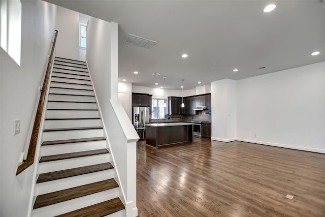 stairway with hardwood / wood-style flooring