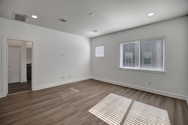 spare room featuring dark hardwood / wood-style floors