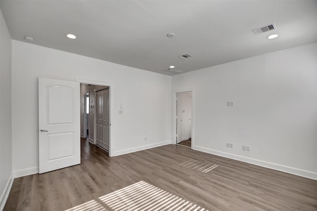 empty room with hardwood / wood-style floors