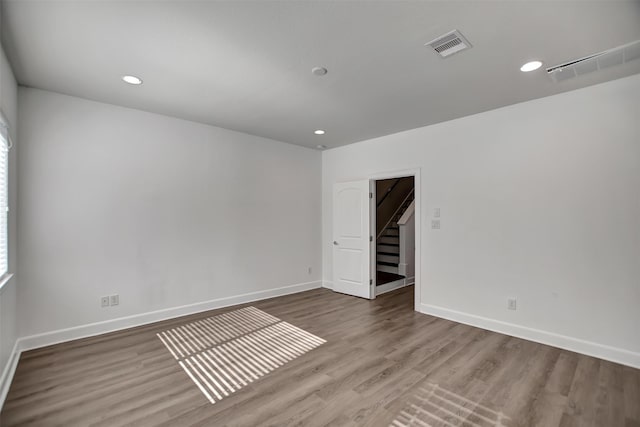 spare room featuring wood-type flooring