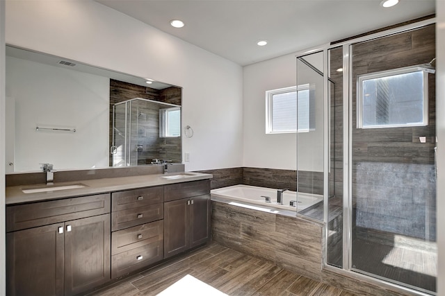 bathroom with plus walk in shower and vanity