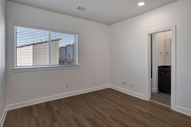 spare room with dark hardwood / wood-style floors