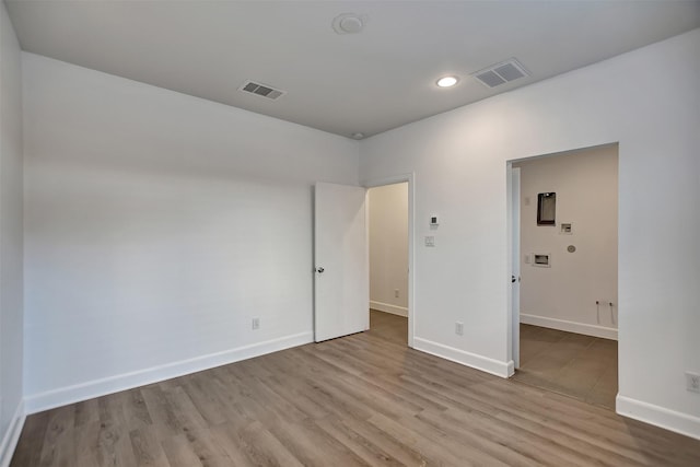 empty room with light hardwood / wood-style floors