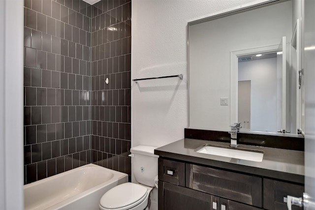 full bathroom featuring vanity, tiled shower / bath combo, and toilet