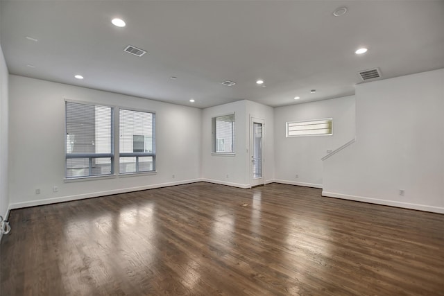 interior space with dark hardwood / wood-style flooring and plenty of natural light