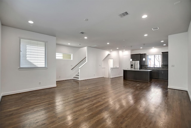 unfurnished living room with dark wood-type flooring