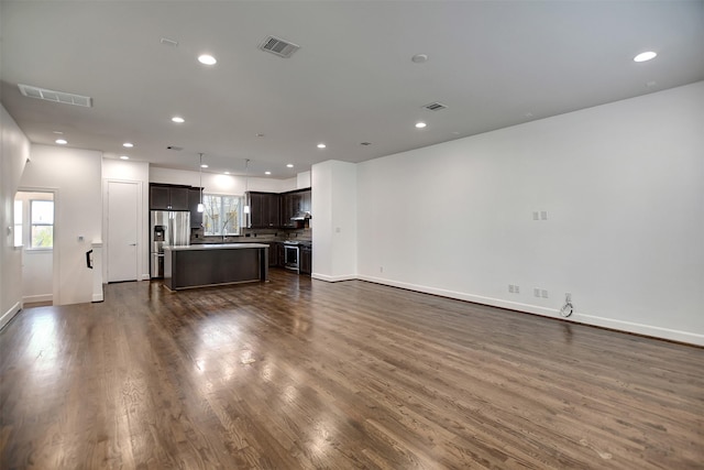 unfurnished living room with dark wood-type flooring