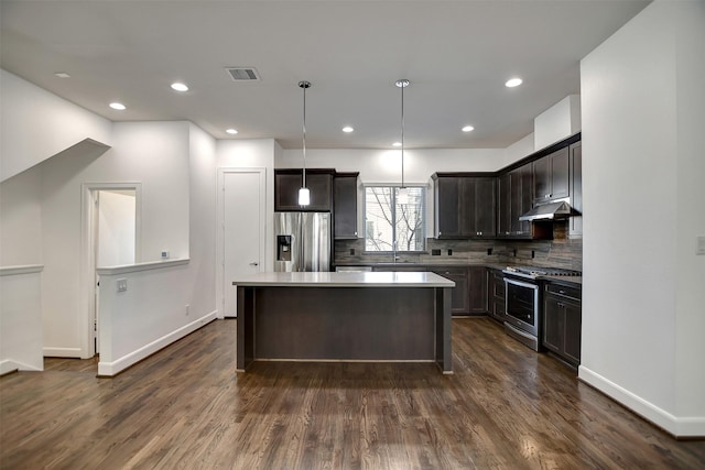 kitchen featuring a kitchen island, pendant lighting, sink, stainless steel appliances, and dark brown cabinets