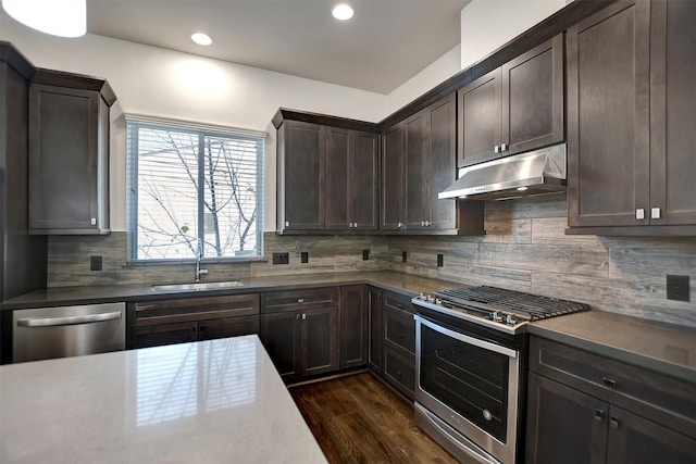 kitchen featuring dark brown cabinetry, sink, dark hardwood / wood-style floors, and appliances with stainless steel finishes