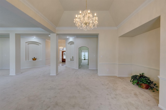 carpeted spare room featuring a notable chandelier, crown molding, and vaulted ceiling