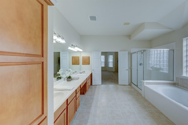 bathroom featuring tile patterned flooring, shower with separate bathtub, and vanity