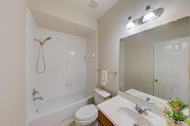 full bathroom featuring tiled shower / bath, vanity, and toilet