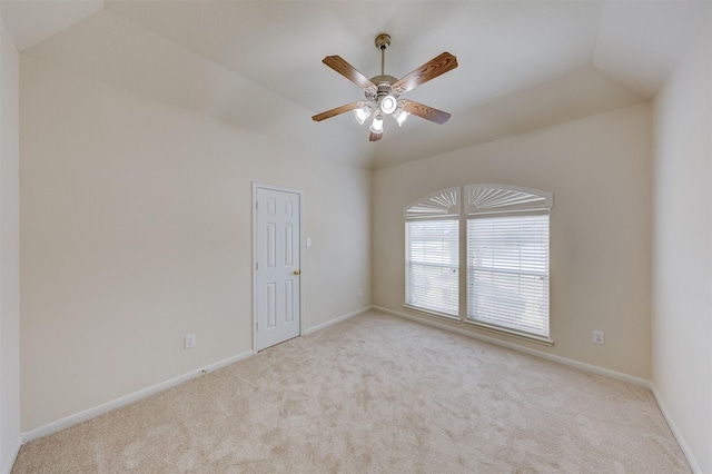 unfurnished room with ceiling fan, lofted ceiling, and light carpet