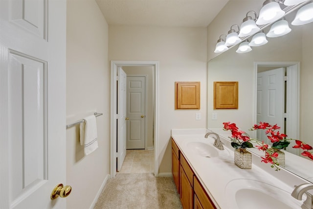 bathroom featuring vanity, tile patterned flooring, and a chandelier