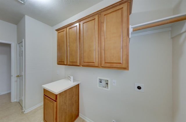 laundry area with cabinets, hookup for an electric dryer, and hookup for a washing machine