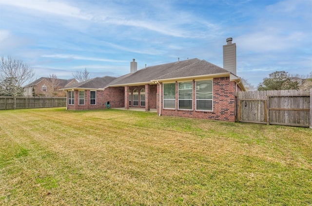 back of house with a yard