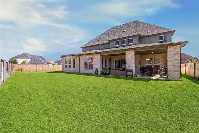 rear view of house featuring a patio area, a fenced backyard, a lawn, and brick siding