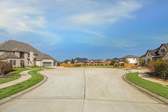 view of road with sidewalks, a residential view, and curbs