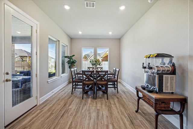 dining space with baseboards, visible vents, wood finished floors, and recessed lighting