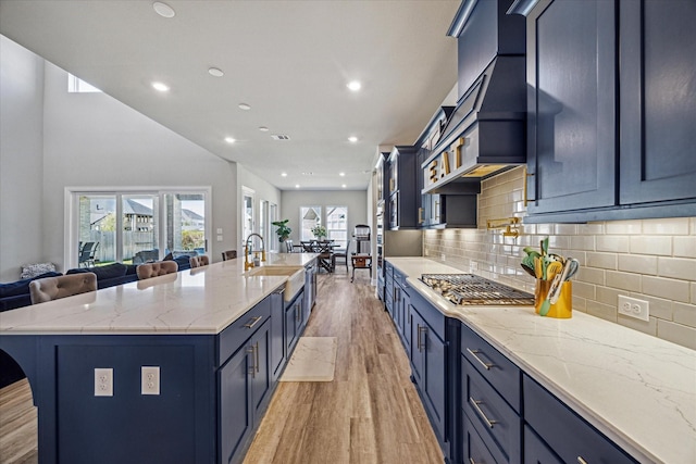 kitchen with a spacious island, blue cabinetry, and open floor plan