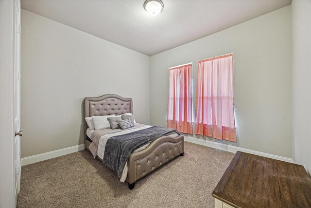 bedroom featuring carpet floors and baseboards