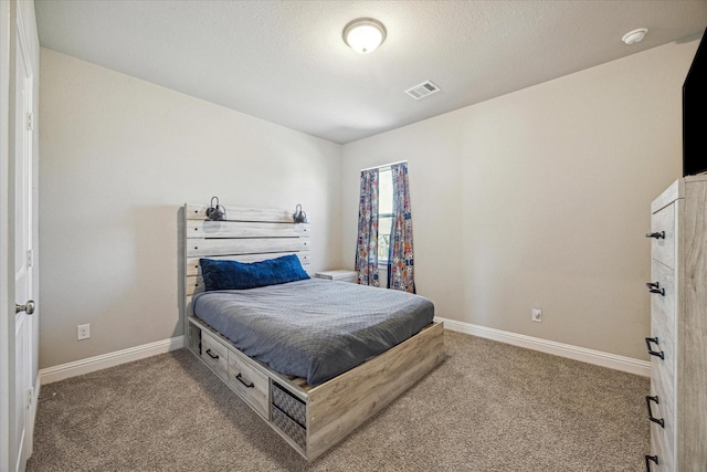 bedroom featuring carpet floors, visible vents, a textured ceiling, and baseboards