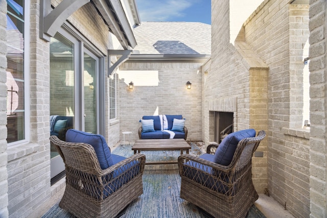 view of patio featuring an outdoor brick fireplace