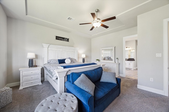 bedroom featuring baseboards, visible vents, ceiling fan, carpet, and a tray ceiling