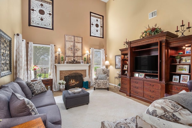 living room featuring a high ceiling and light colored carpet