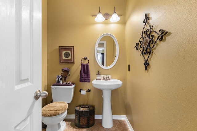 bathroom with tile patterned flooring, sink, and toilet