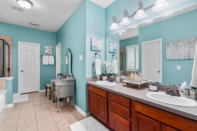 bathroom with tile patterned flooring, vanity, and plus walk in shower