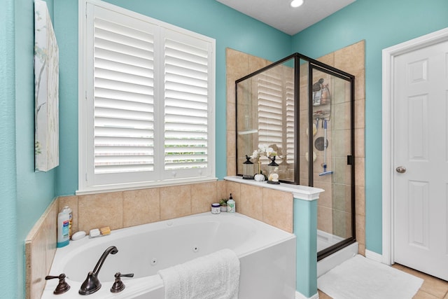 bathroom featuring shower with separate bathtub