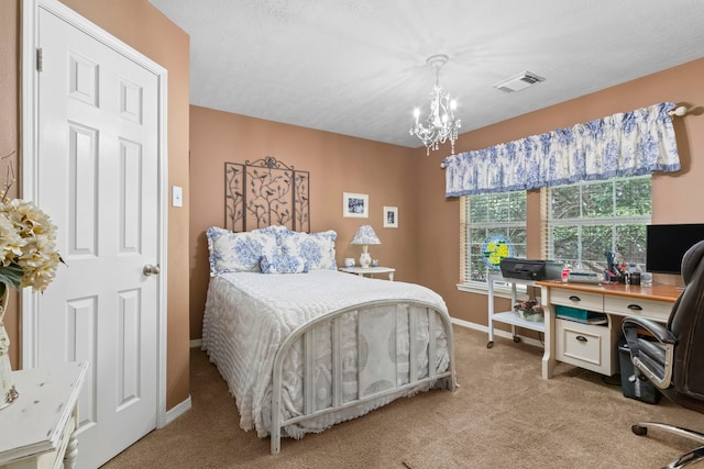 carpeted bedroom with a notable chandelier