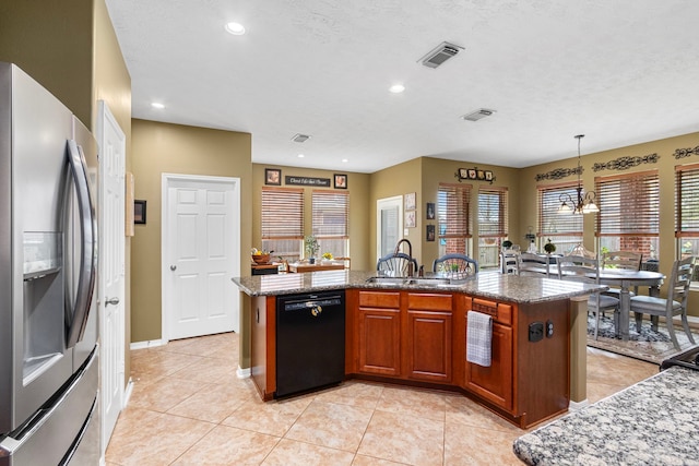 kitchen with sink, hanging light fixtures, a center island with sink, stainless steel fridge, and dishwasher