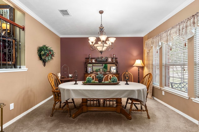 dining room featuring ornamental molding, a chandelier, and carpet floors