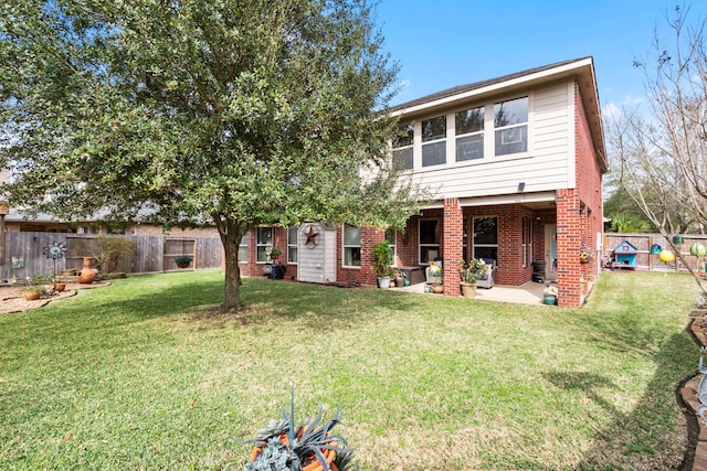 back of property featuring a yard and a patio