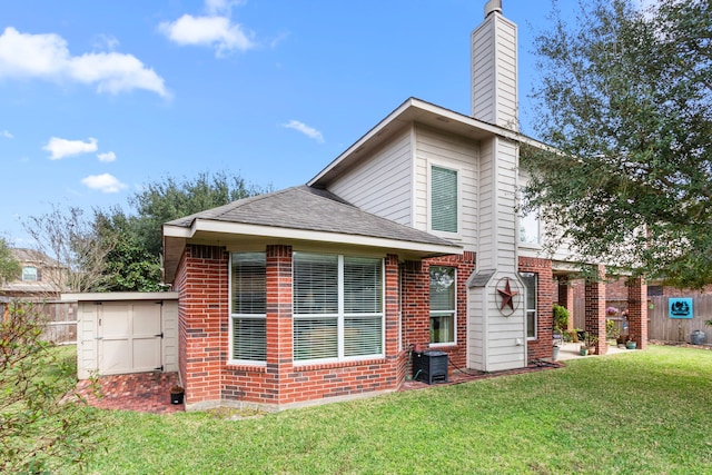 rear view of property with a yard