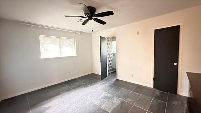 unfurnished bedroom featuring ceiling fan