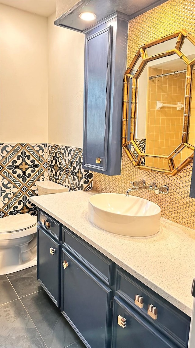 bathroom with tasteful backsplash, vanity, and toilet