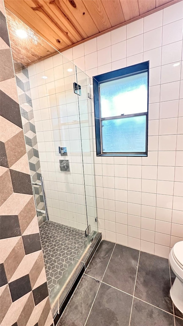 bathroom featuring a shower with shower door, tile patterned floors, wooden ceiling, and toilet