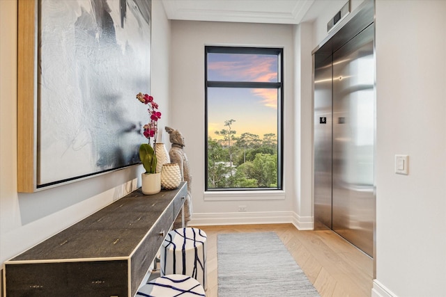 mudroom with elevator and light hardwood / wood-style flooring