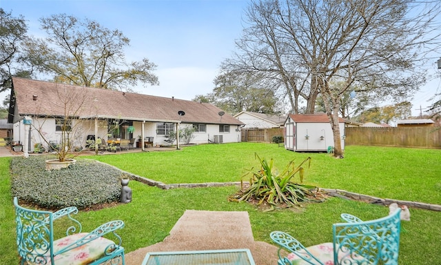 view of yard with a storage unit and a patio area