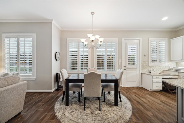 dining room featuring ornamental molding, a notable chandelier, and dark hardwood / wood-style flooring