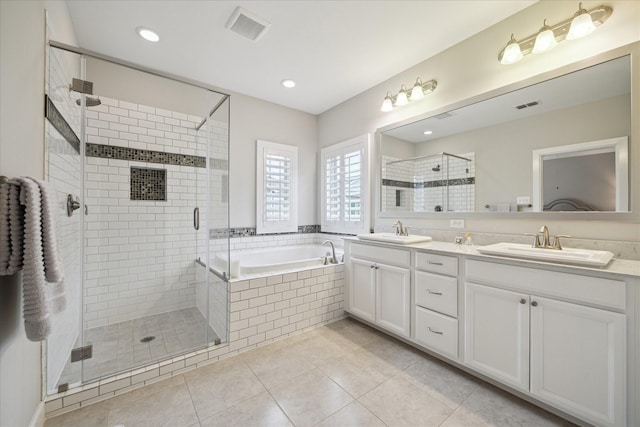 bathroom with independent shower and bath, vanity, and tile patterned flooring