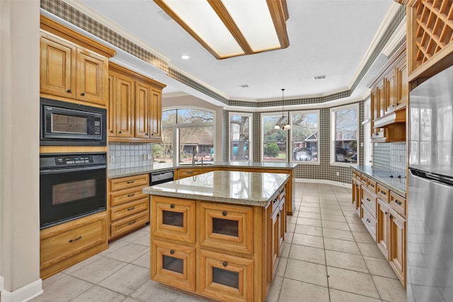 kitchen with sink, hanging light fixtures, a center island, black appliances, and crown molding