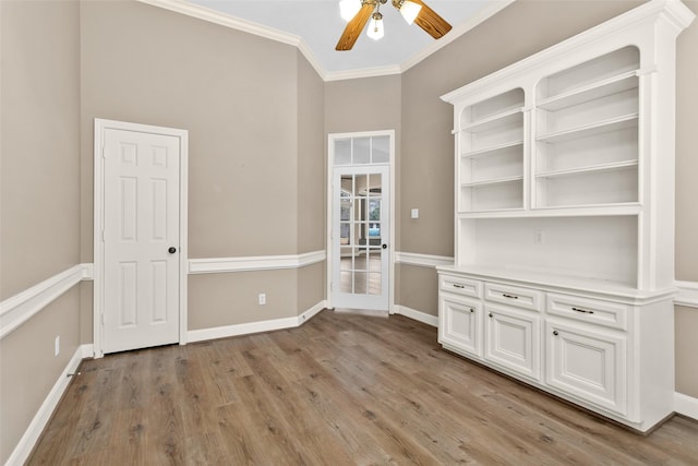 interior space with ceiling fan, ornamental molding, and light hardwood / wood-style floors