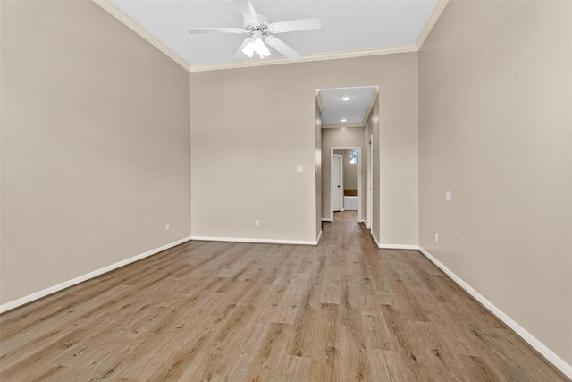 empty room featuring crown molding, ceiling fan, and light hardwood / wood-style floors